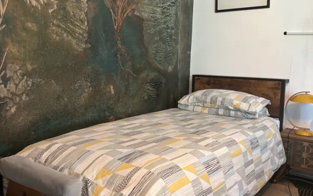 Large single bed in Brixton, London. Clothing optional.