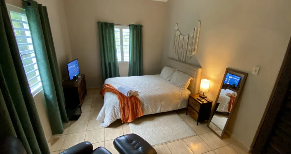 Chris & Wil's listing on misterb&b - Bedroom # 2, 138 sq ft.  This private corner room has a ceiling fan, individual ac, 32 inch TV, recliner, closet and drawers. This room shares a hall bathroom with other guests. 