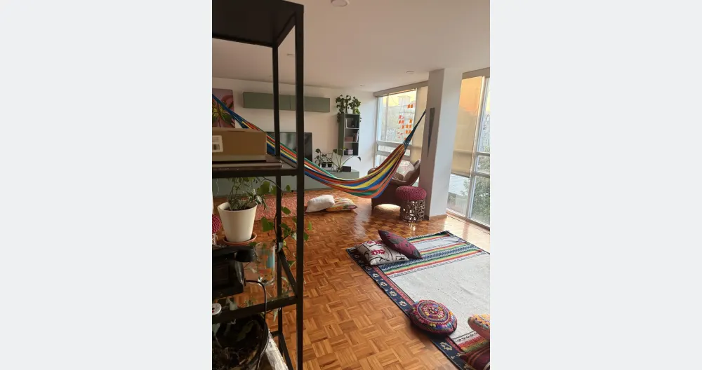 Jaime's listing on misterb&b - Common area with hammock, rugs and cushions. Clothing optional and 420 friendly.