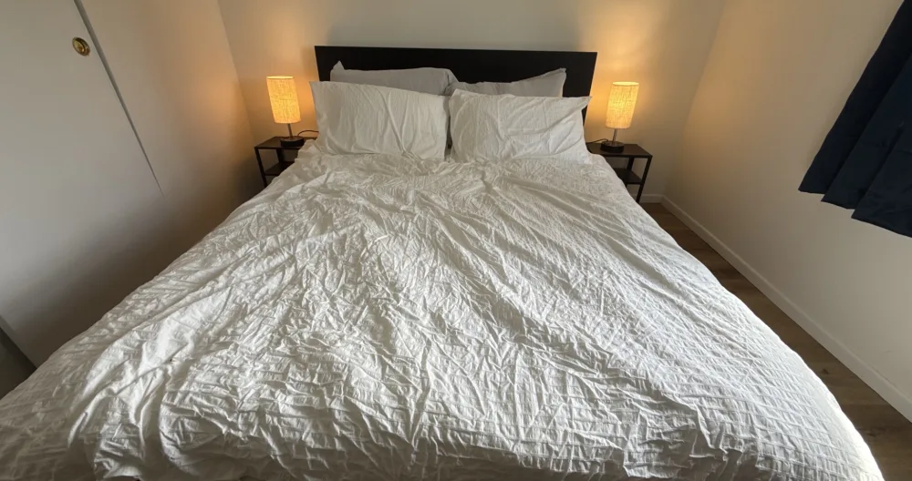 Trevor's listing on misterb&b - Guest bedroom features matching table lamps with USB and 120V charging options.