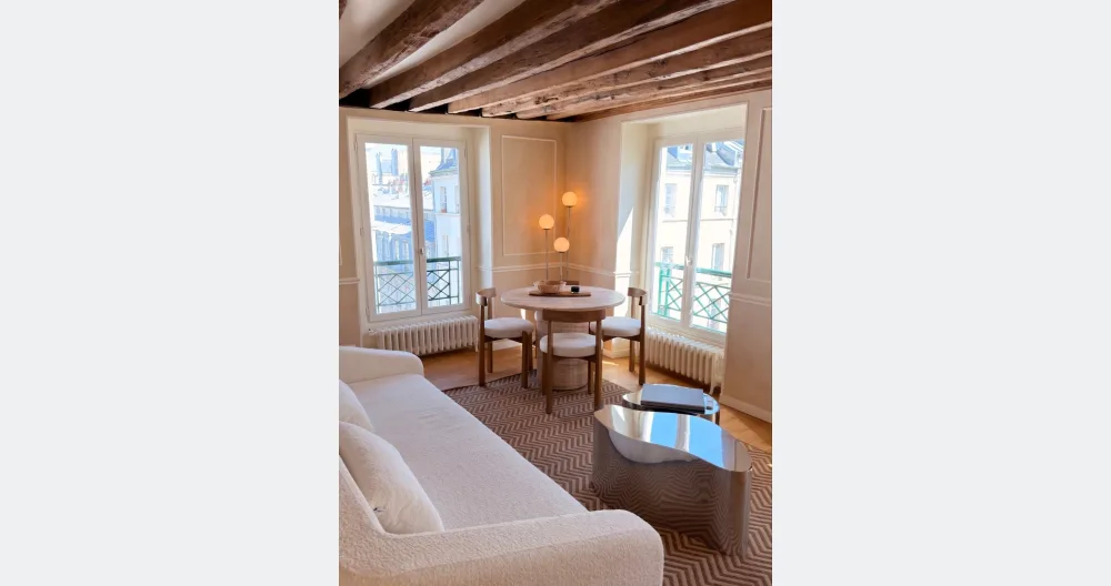 Olivier's listing on misterb&b - The living room and dining room with a beautiful view of the Paris skyline
